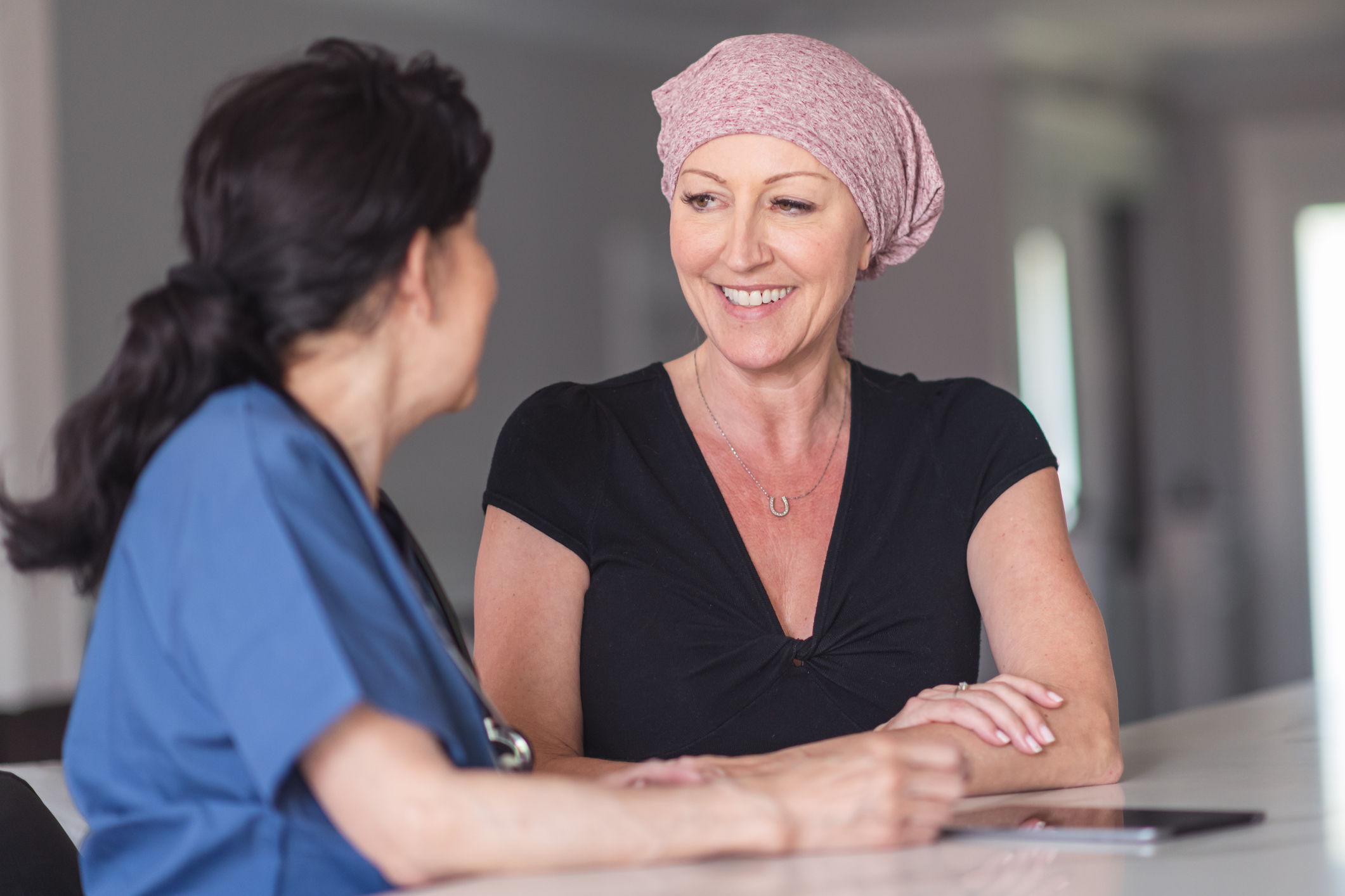 a woman meets with her cancer care team patient navigator