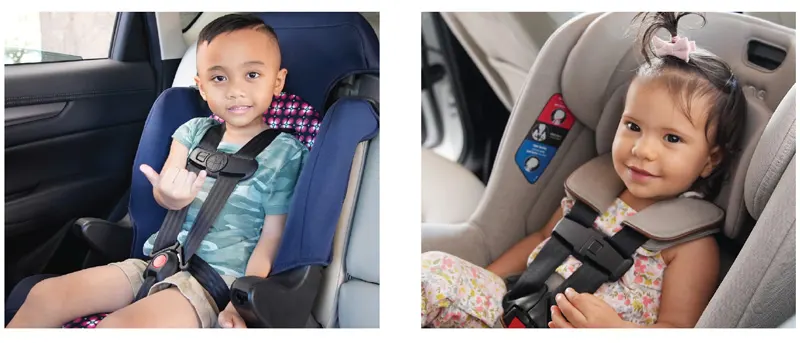 2 children safely sitting in their car seat and smiling.