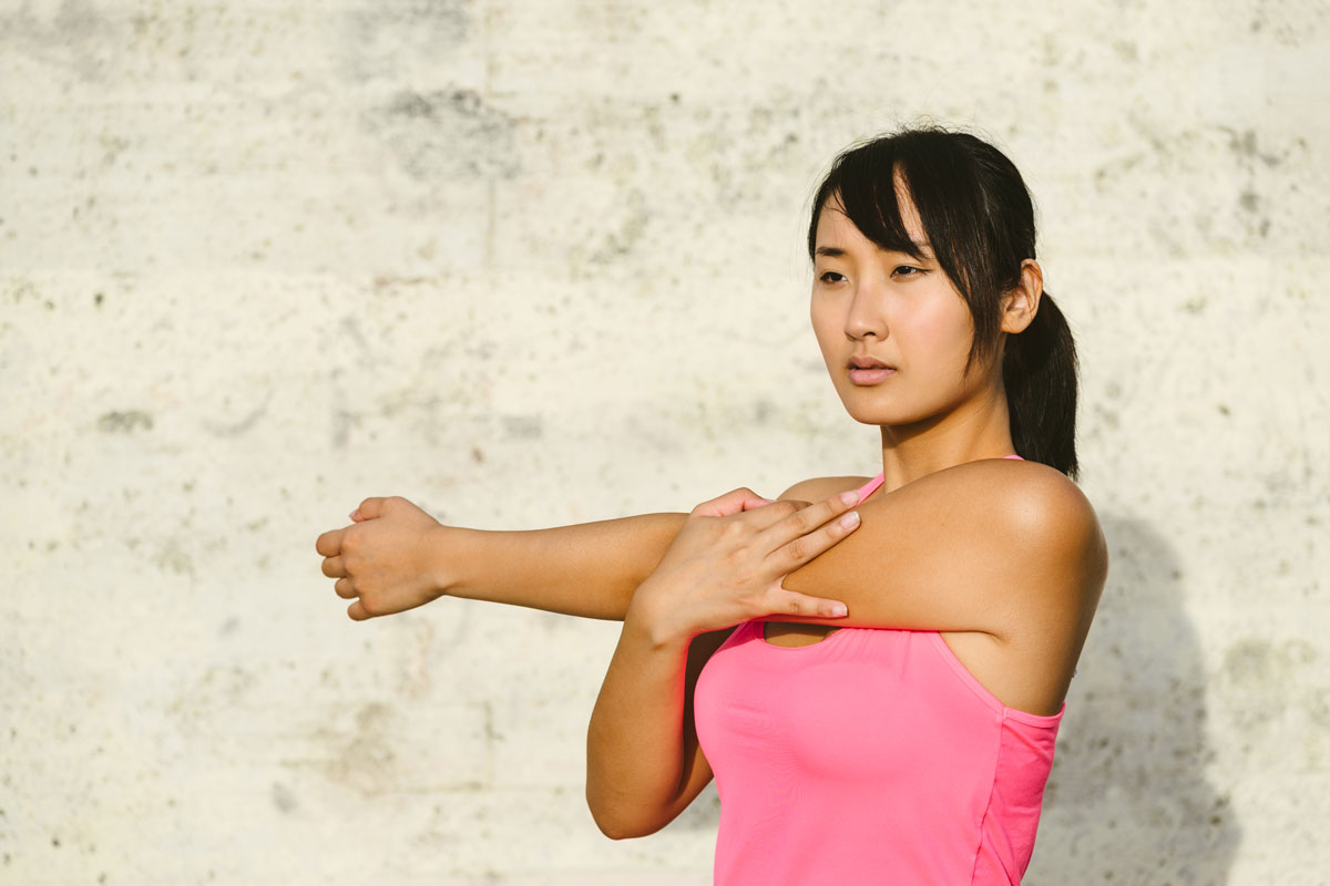 A woman stretching her arm.