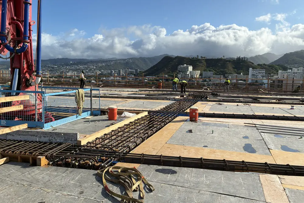 Rebar, forms, and equipment prepared for a concrete pour on Level 21.