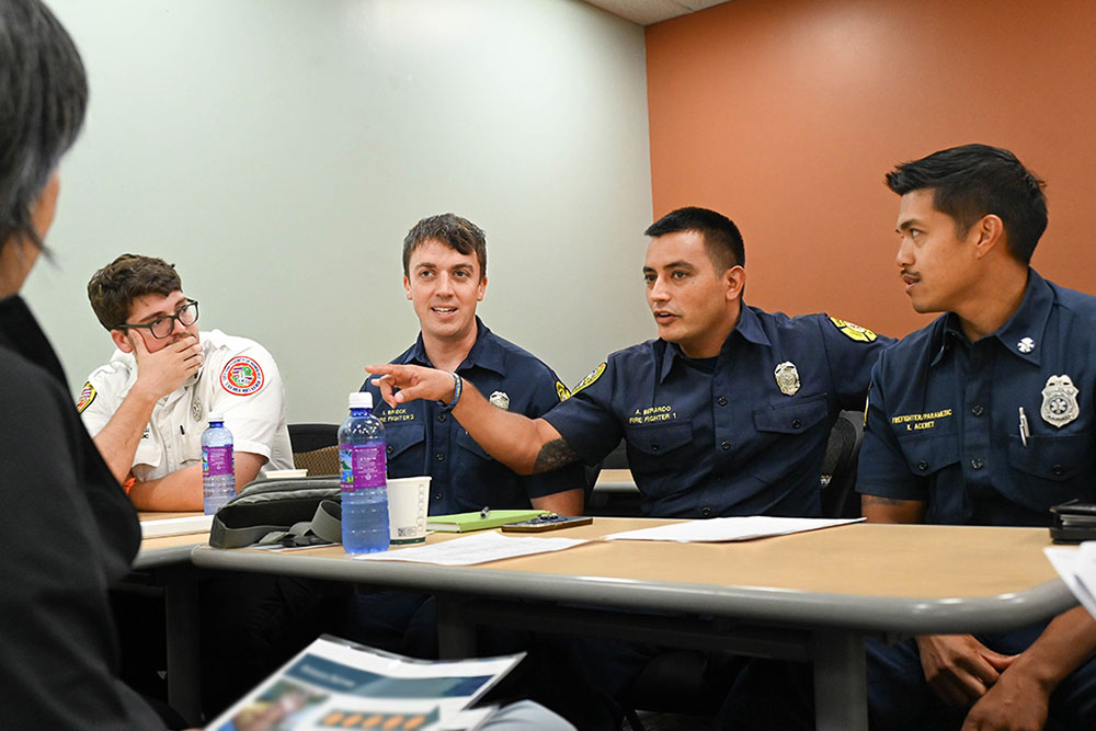 Uniformed first responders in a classroom.