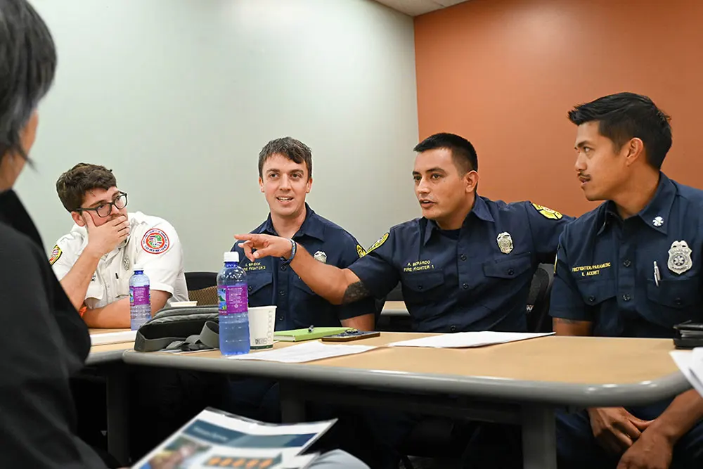 Uniformed first responders in a classroom.