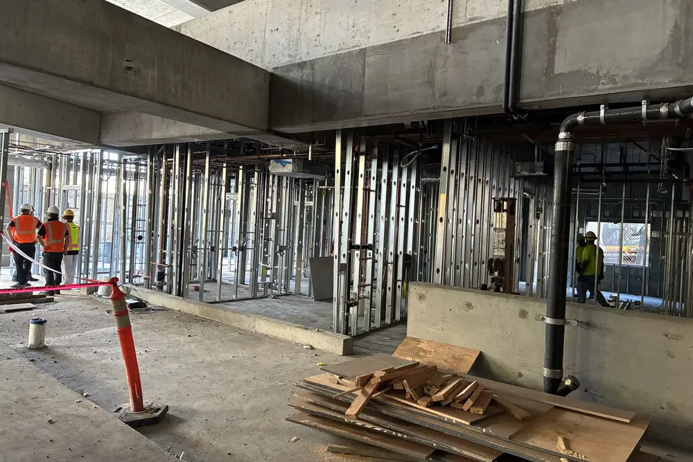 Metal wall framing and utility lines inside the Level 1 office area.