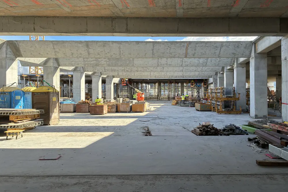 Rooftop trellis beams span an active construction area on Level 20.
