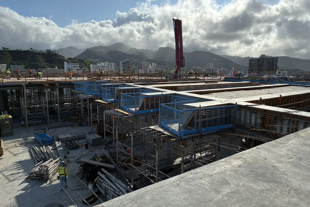 Newly poured rooftop trellis beams surrounded by temporary supports.