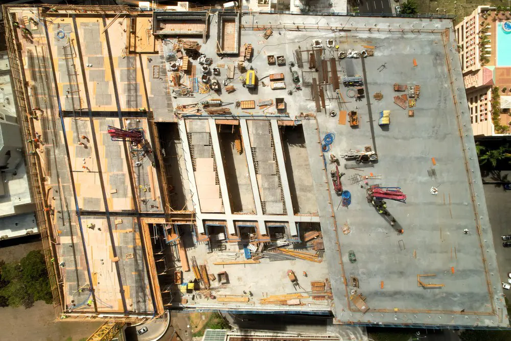 Top-down aerial view of concrete work across the parking building roof.