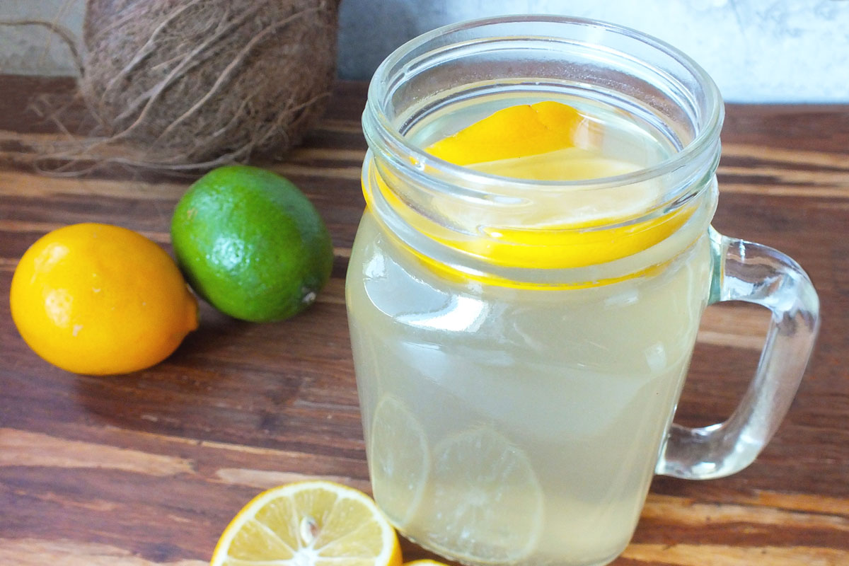 Water jug with slice of lemon.